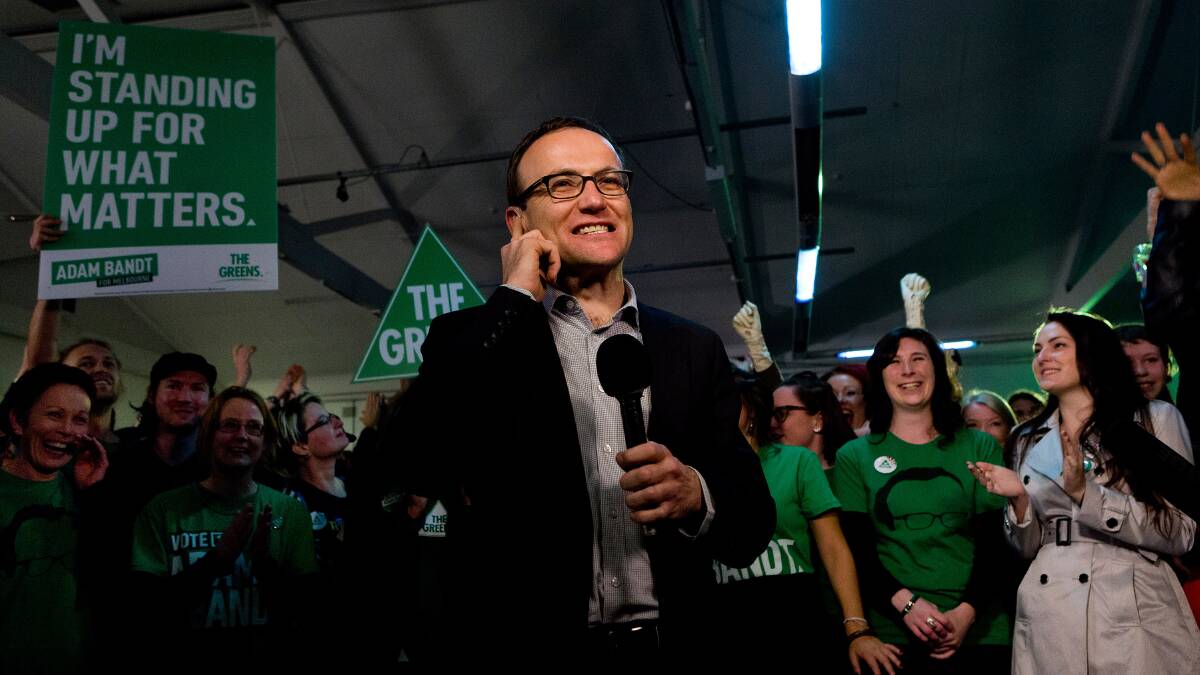 Adam Bandt speaks on a live cross from the Greens election event at the People's Market, West Melbourne. Photo: PAUL JEFFERS