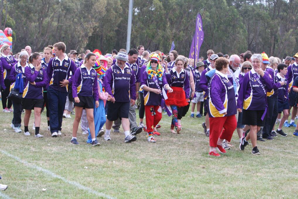 Purple-clad participants, many embracing the circus theme, begin the Relay for Life at Deakin University oval last night. A record 52 teams are taking part this year.
