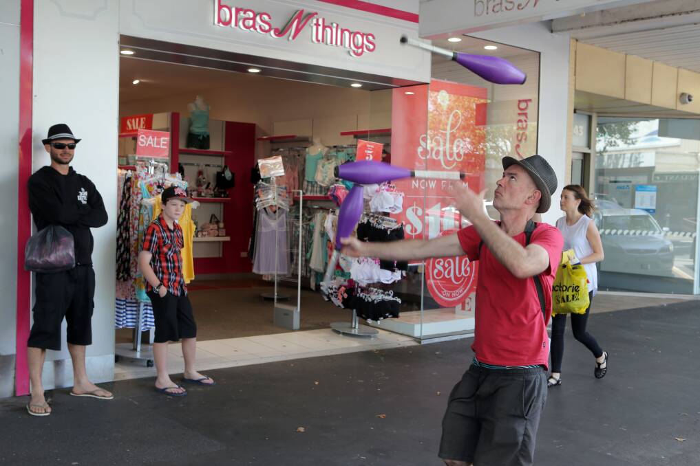 A juggler entertains in Liebig Street, Warrnambool as shoppers venture out for yesterday’s Boxing Day sales. 
