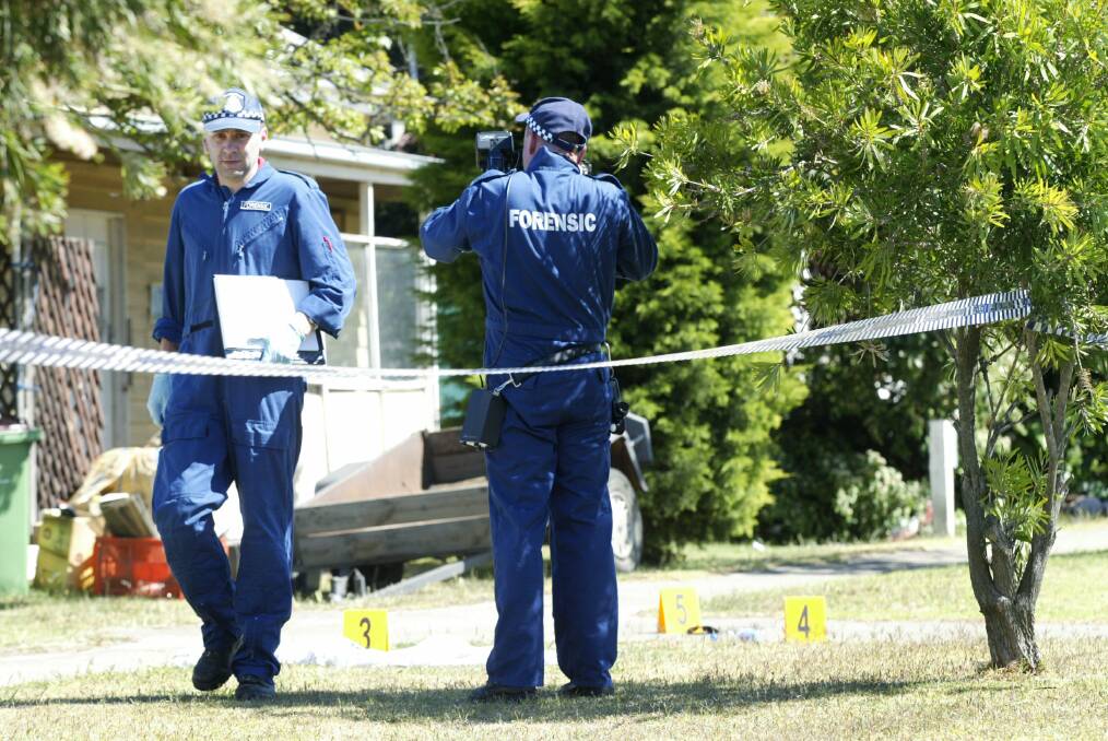 Melbourne homicide squad detectives  examine the murder scene at Portland’s Hurd Street in 2006. 