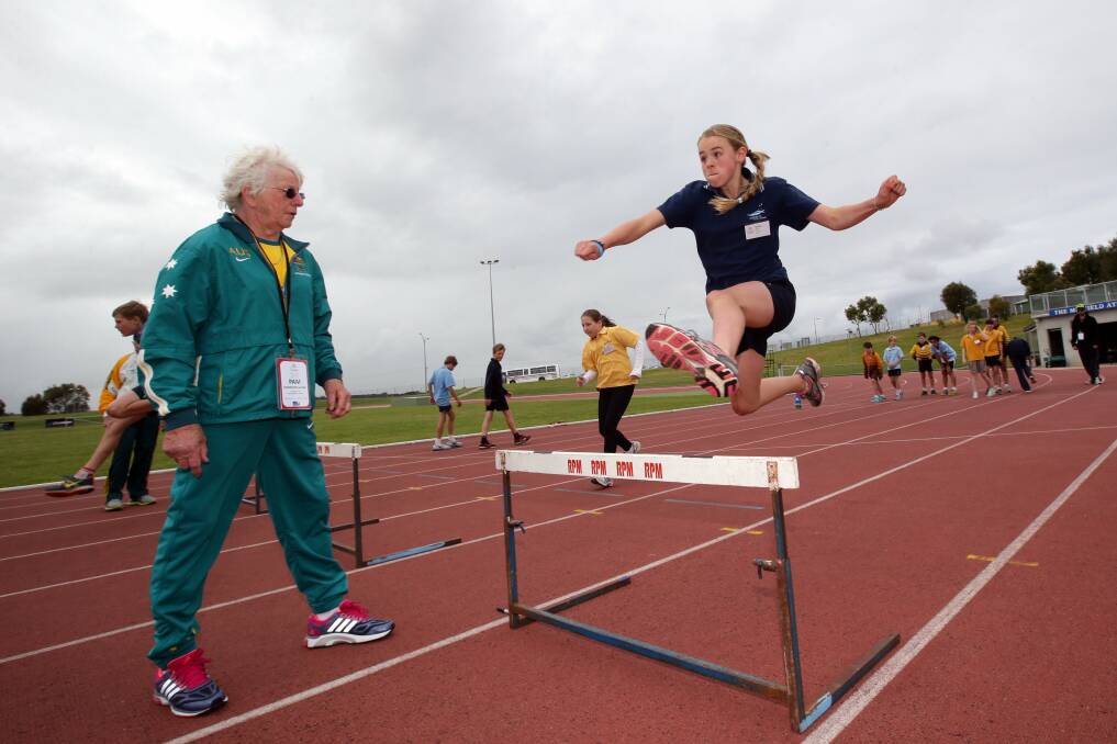 Three-time Olympian Pam Kilborn-Ryan watches Maddi Giblin, 12, from Merrivale Primary School go over the hurdles.
