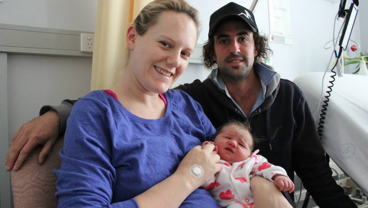 Cassi and Matt Barton with their first daughter Imogen who was born on Monday. Imogen will now share the same birthday as the newly born British prince. PHOTO: DARREN SNYDER 