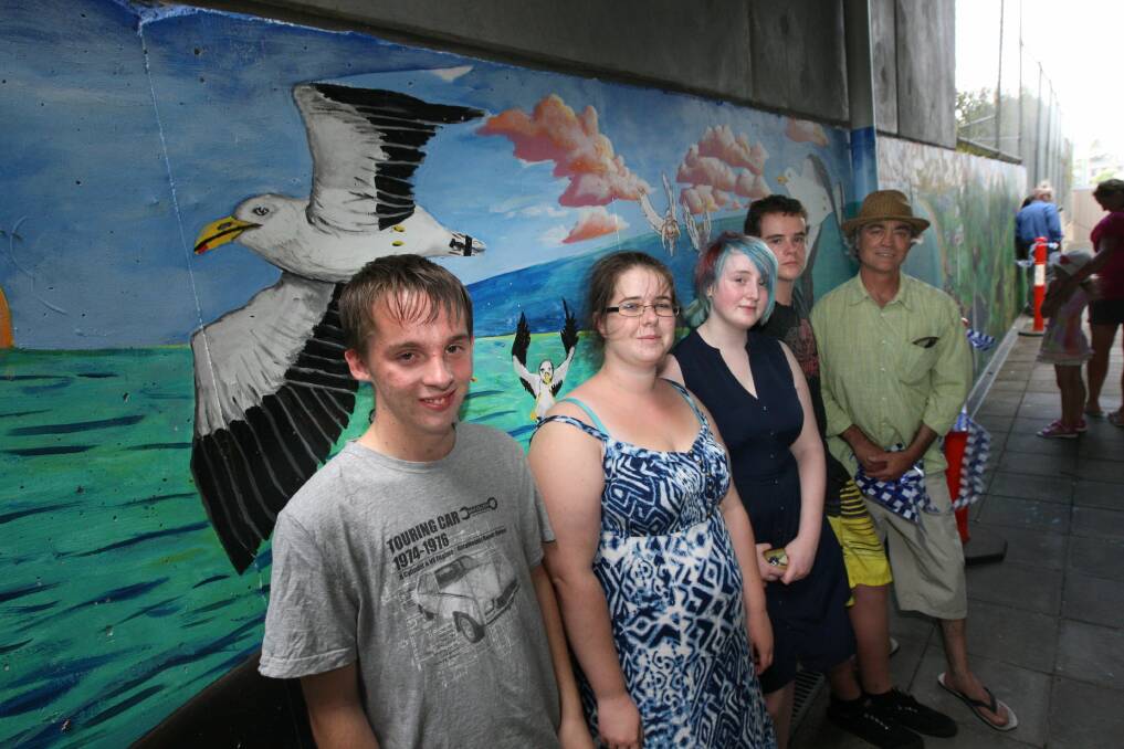 Artists who worked on the mural included: Nathan Benson (left), Laura McKay, Izzy Clark and Jackson Huntley with Francis Van Der Mark. 