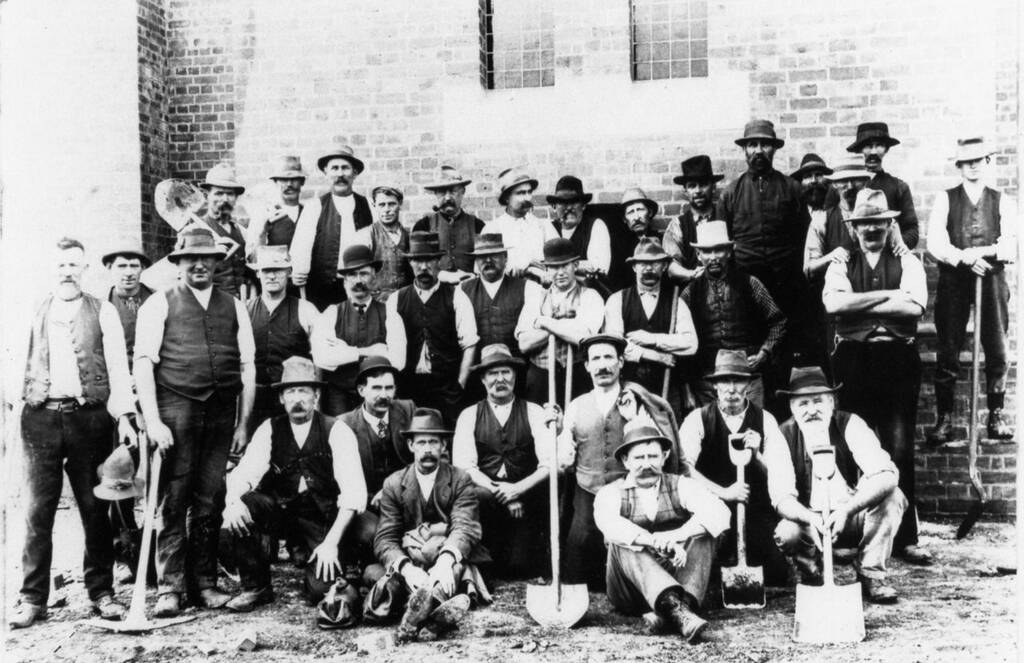 Hats, vests, shovels and muscles: the builders of St Brigid’s Church, Crossley, pose for the camera a hundred years ago. 