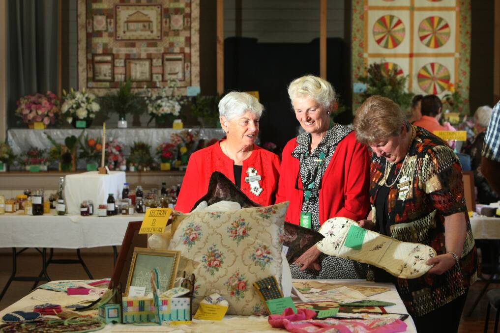Craft convener Lorraine Steff (left), group president Bev Byron and secretary Pam Andrew with some of the craft works on display at the CWA Home Industries and Craft Exhibition. 