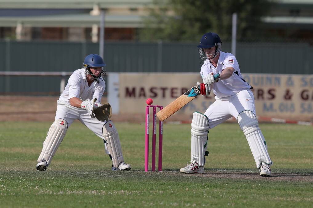 Heytesbury Rebels batsman Craig Murrell attempts a cut shot as Cobden wicketkeeper Leigh Walsh is poised to pounce.