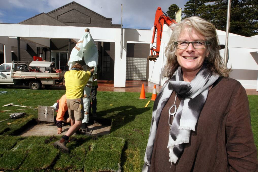 Artist and The Guardians creator Shona Nunan watches as workers erect one of her sculptures outside Warrnambool Art Gallery yesterday. The pair of bronze figures will be officially unveiled this evening.  