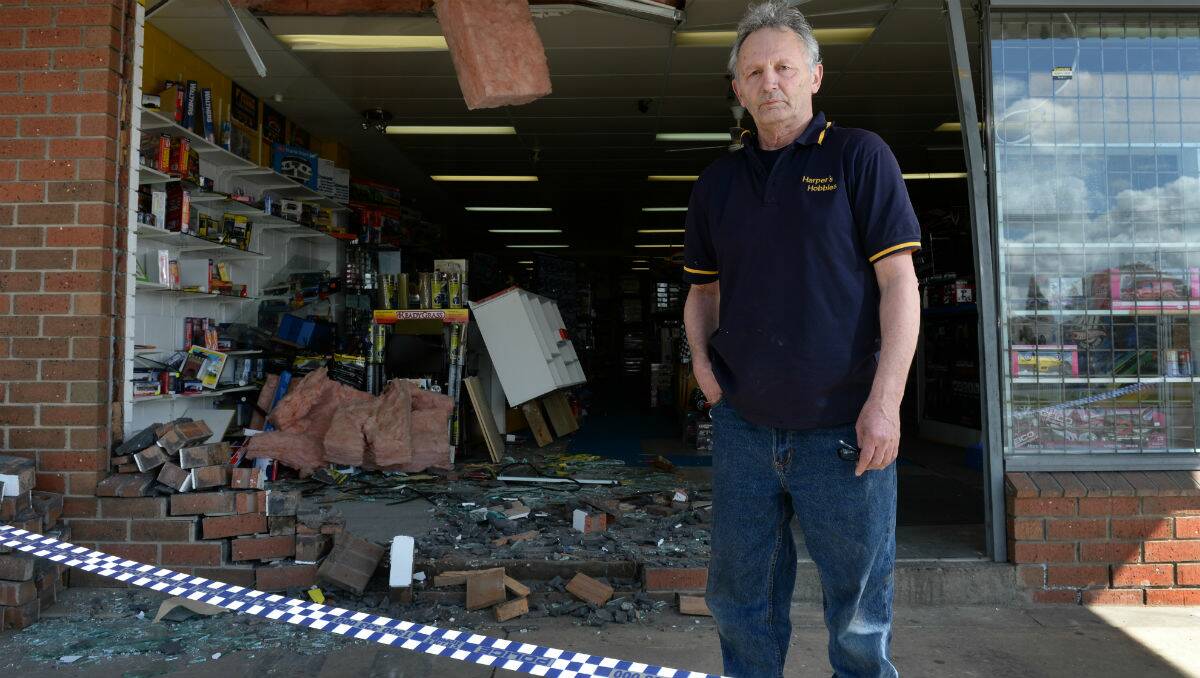 Owner Toni Cini outside Harpers Hobbies and Collectables in front of the damage to his store. PICTURE: ADAM TRAFFORD