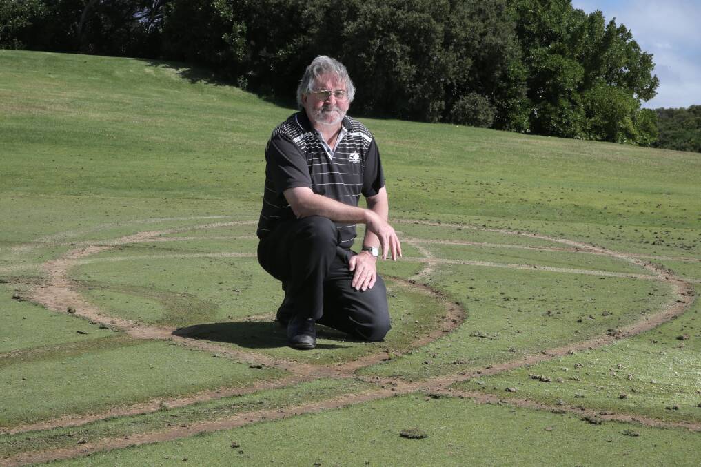 Warrnambool Golf Club manager Trevor Brown inspects damage to the third green. 