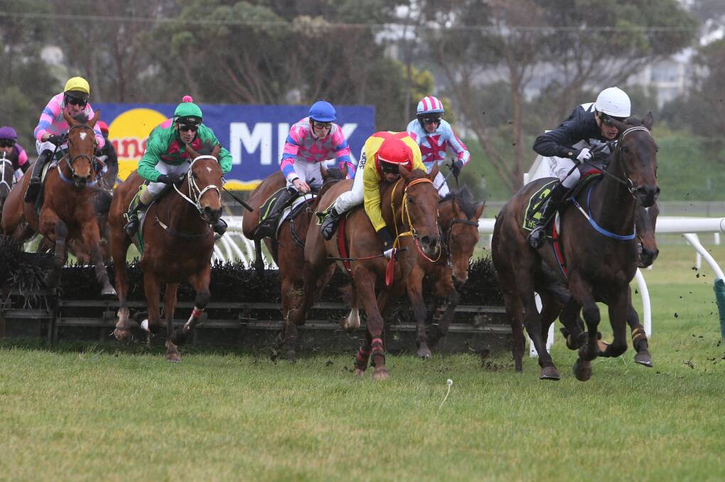 Rider Arron Lynch has About The Journey (rear, third from left) stalking the leaders at the last jump in the maiden hurdle. Jockey Clayton Douglas (centre) is almost dislodged from Tough Vintage but regains his balance to finish fourth.    140810AM05 Picture: ANGELA MILNE