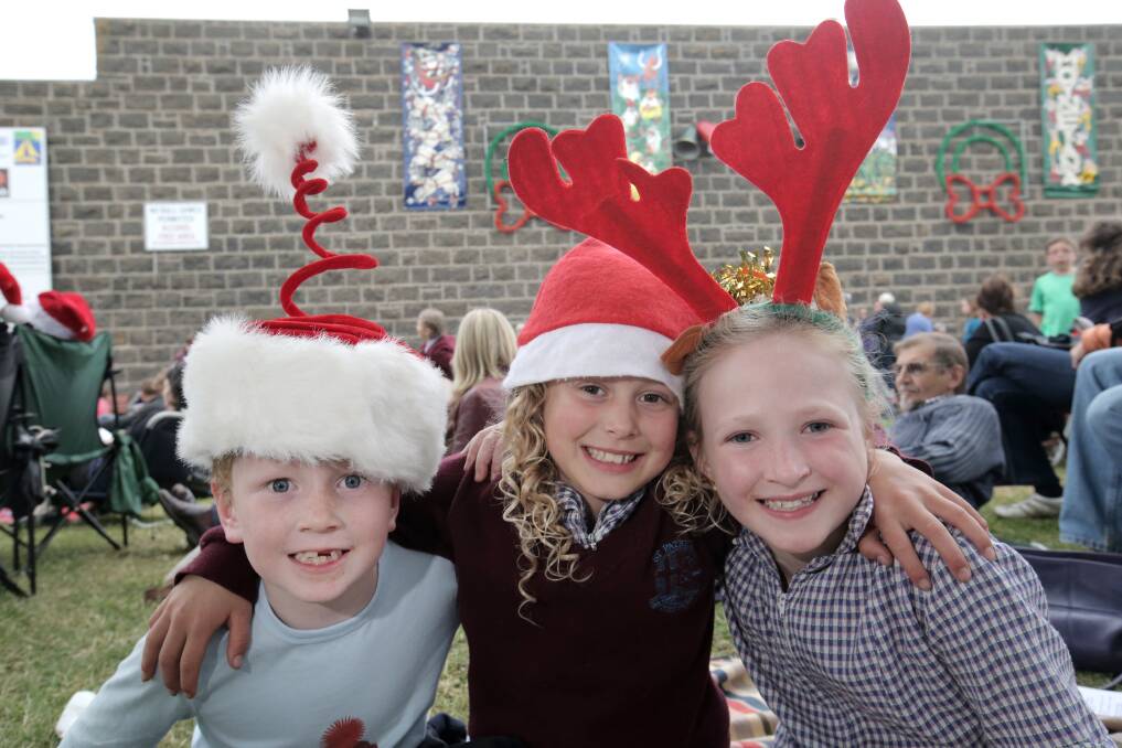 Sam Graham, 5 (left), Demi Sharp, 9, and Milly Graham, 8, get in the festive mood last night in Port Fairy.