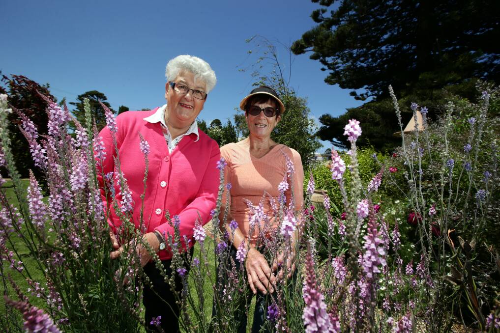 Port Fairy Rotary Club president Hester Woodrup admires Melrose Garden with its owner Dot Cashmore. 