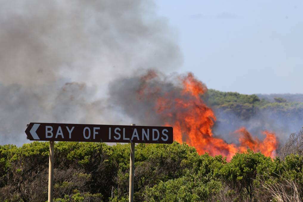 Flames lick at scrub near the Great Ocean Road at the Bay of Islands. 