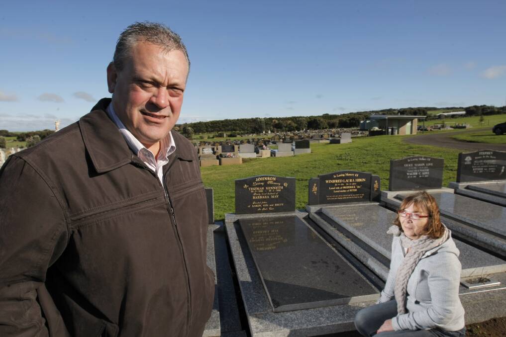 Thomas (Ken) Johnson’s son Brett Johnson, of Westmere, and niece Jenny Clow, of Camberwell, at the former firefighter’s grave at Tower Hill.