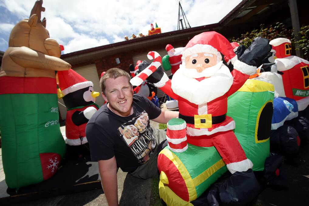 Christmas lights competition winner Cameron Hardwick with some inflatable friends at 6 Marlee Court, Warrnambool.