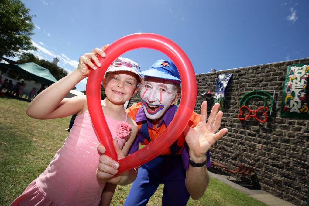 Red the Clown inflates the fun level for  Niamh McCrohan, 8, of Port Fairy, at the seaside town’s village square. 