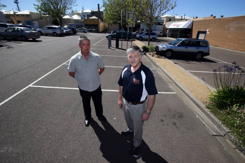 Empty car bays in Ozone car park are a worrying sign at Christmas for Boolistic store owner Mick Peters (left) and Warrnambool Disposals owner Dennis Bunworth. 