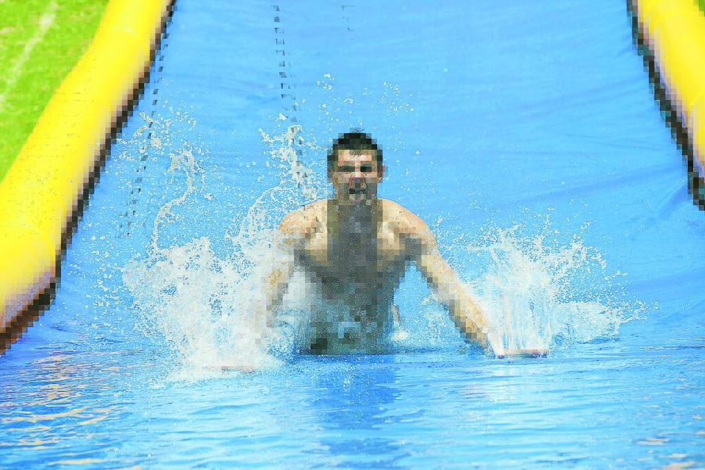 Lifeguard Adam Barnes and his fellow AquaZone staff members had a ball testing out the aquatic centre’s new slippery slide yesterday — perfectly timed with the arrival of some genuine summer weather. 