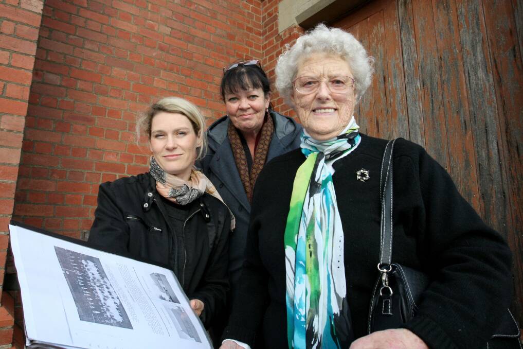 Historian Dr Helen Doyle (left), with Jean Evens and Dorothy Ryan (formerly Madden) look at some old school photos in which Mrs Ryan is pictured.