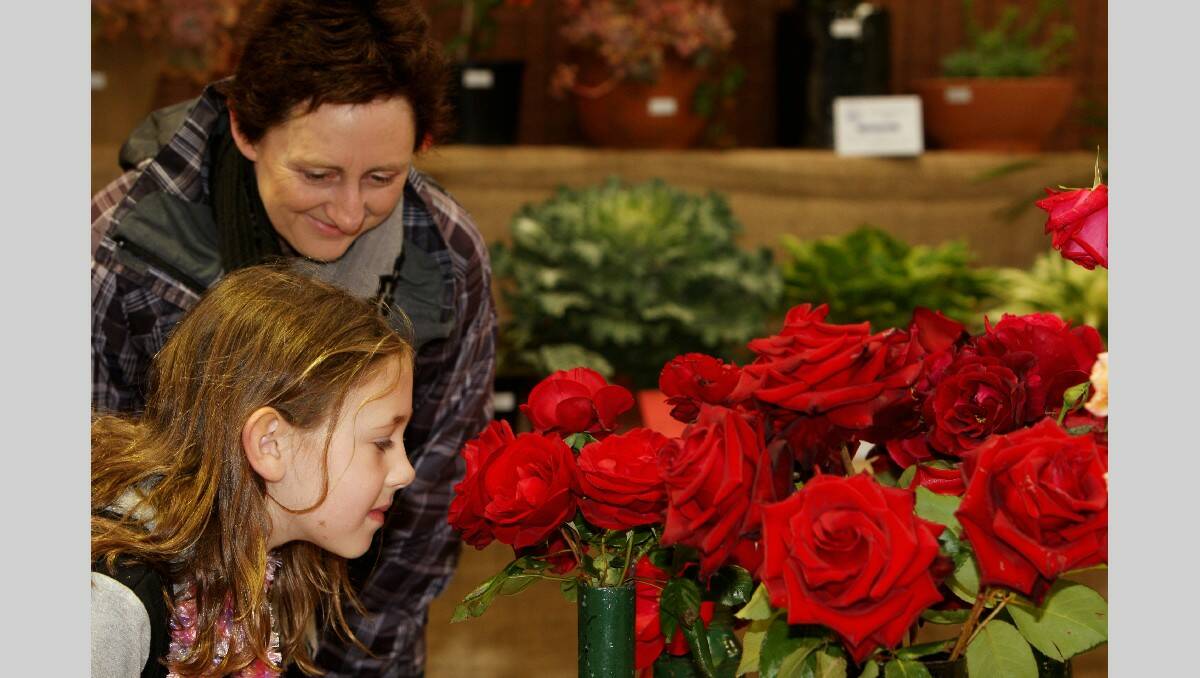 Warrnambool Show 2013: Flower show L-R: Janet Creed with her daughter 9 yr old Gemma Creed from Allansford smelling the roses.  131026LP71 Picture:LEANNE PICKETT