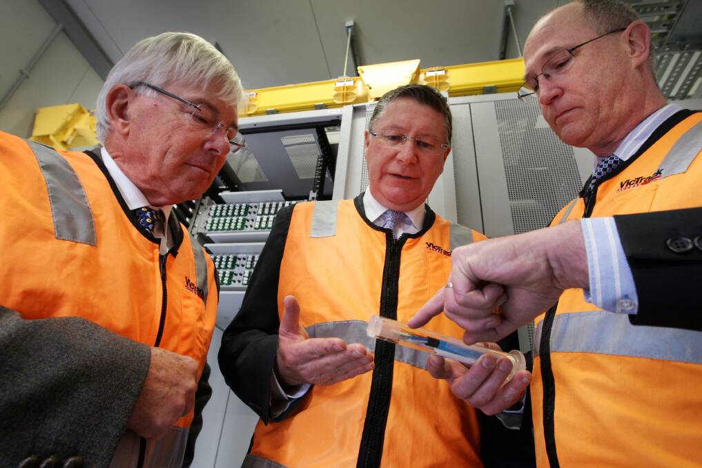 South West TAFE acting board chairman Bill Hewett (left), Premier Denis Napthine and VicTrack’s Michael Barrow look at where the fibre optic technology comes into Warrnambool.  