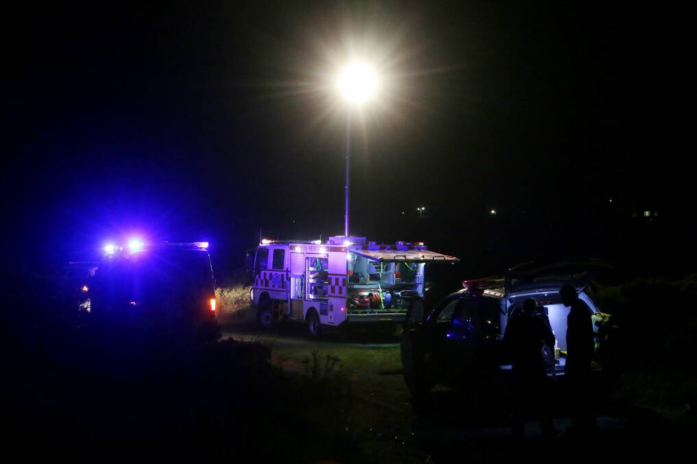 A State Emergency Service floodlight illuminates the scene of last night’s tragedy at the Curdies River, Peterborough. 