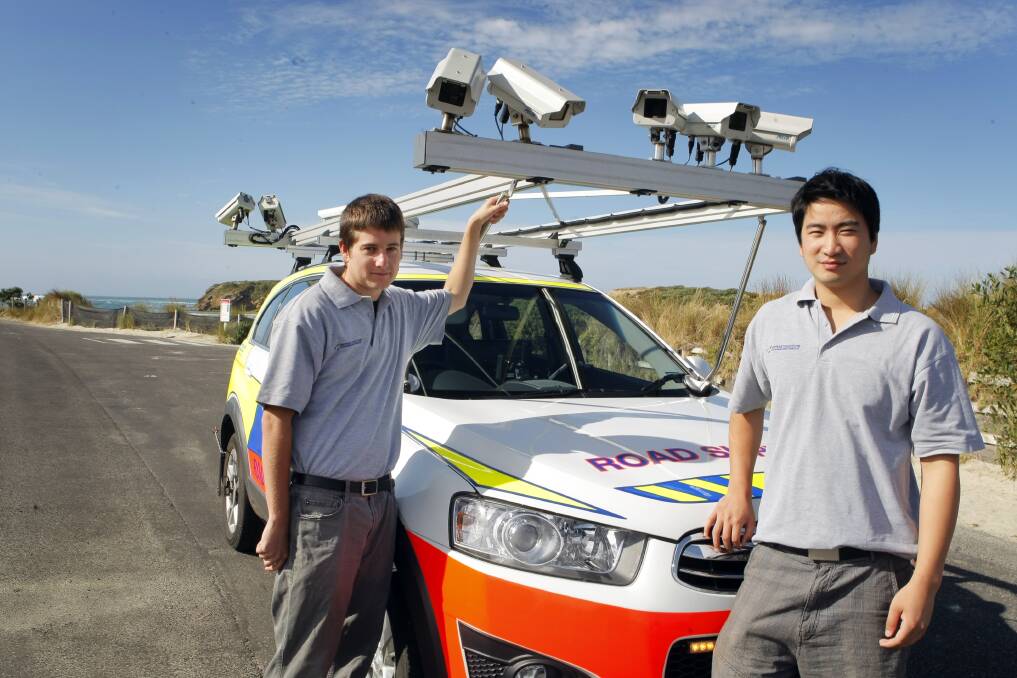 Field technicians Clint Gardner (left) and Jason Zhang, from Infrastructure Management Group, and their camera-clad road survey vehicle. 