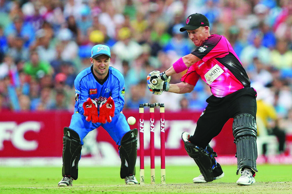 Wicketkeeper Tim Ludeman is in good position behind the stumps for Adelaide Strikers as Sydney Sixers captain Brad Haddin plays a shot. 