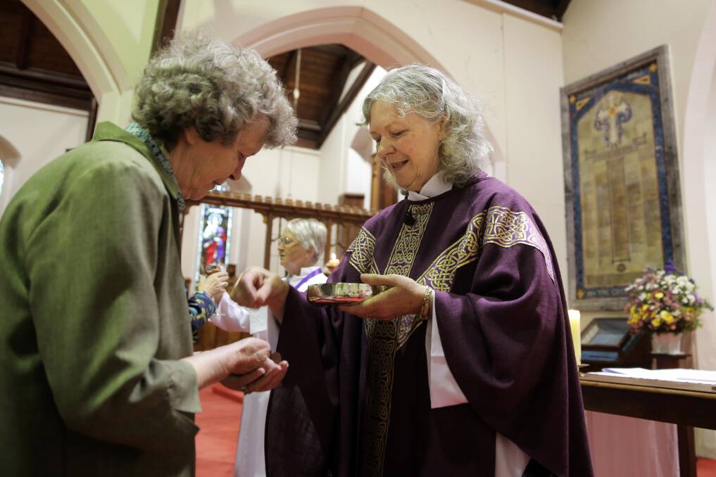 Newly ordained female priest Robyn Shackell conducts her first service at Warrnambool’s Anglican Church yesterday. 