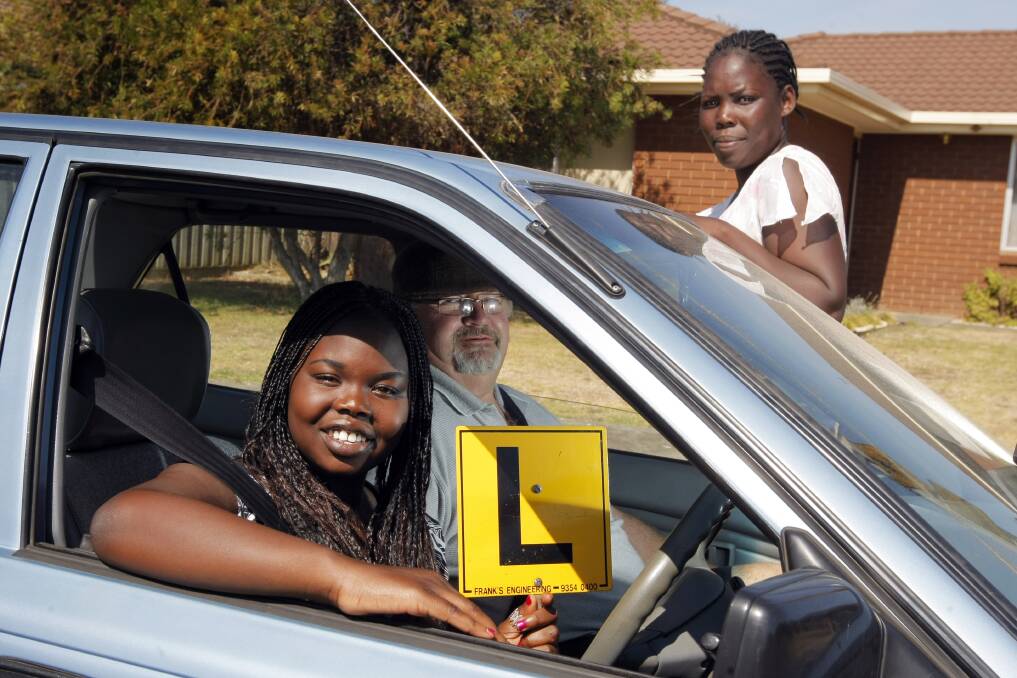 Robert Fleming has been teaching people from non-English speaking backgrounds how to drive, including Afang Malek (left), 18, and Mary Bol, both originally from South Sudan. 