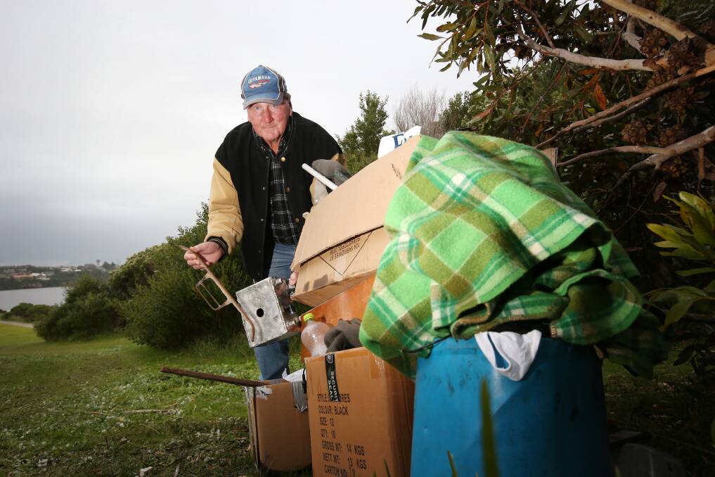 Steve Heazlewood with boxes of household goods he found dumped near the Hopkins River mouth. 140806AS16 Picture: AARON SAWALL