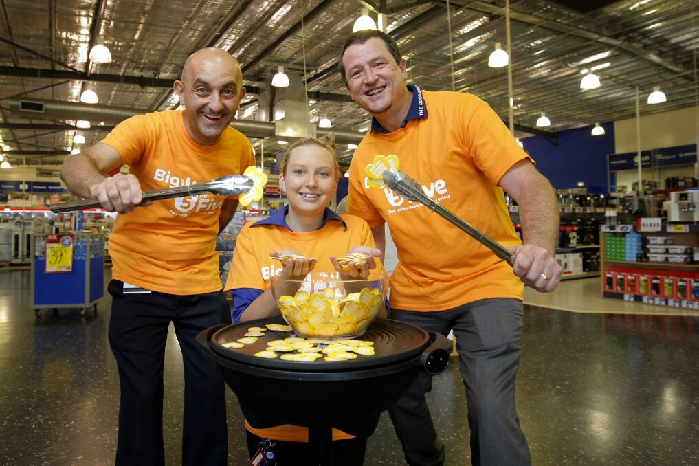 Warrnambool Good Guys staff Peter Sycopoulis (left) and Chantelle Dyson and general manager Jason Morley will be raising money for South West Healthcare today with their orange-theme fund-raiser. 