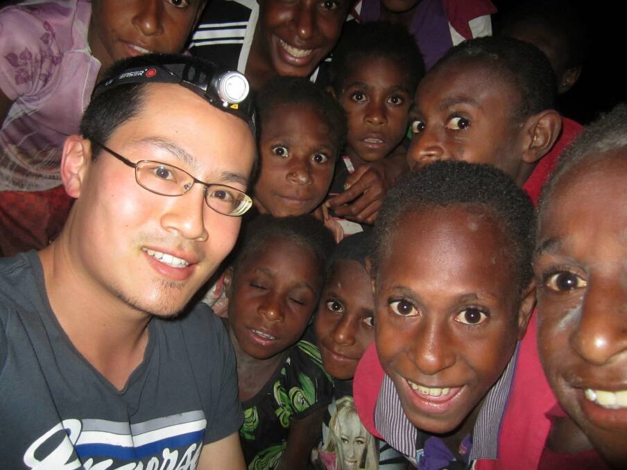Warrnambool dentist Peter Kao befriends some enthusiastic local children at a village in PNG.