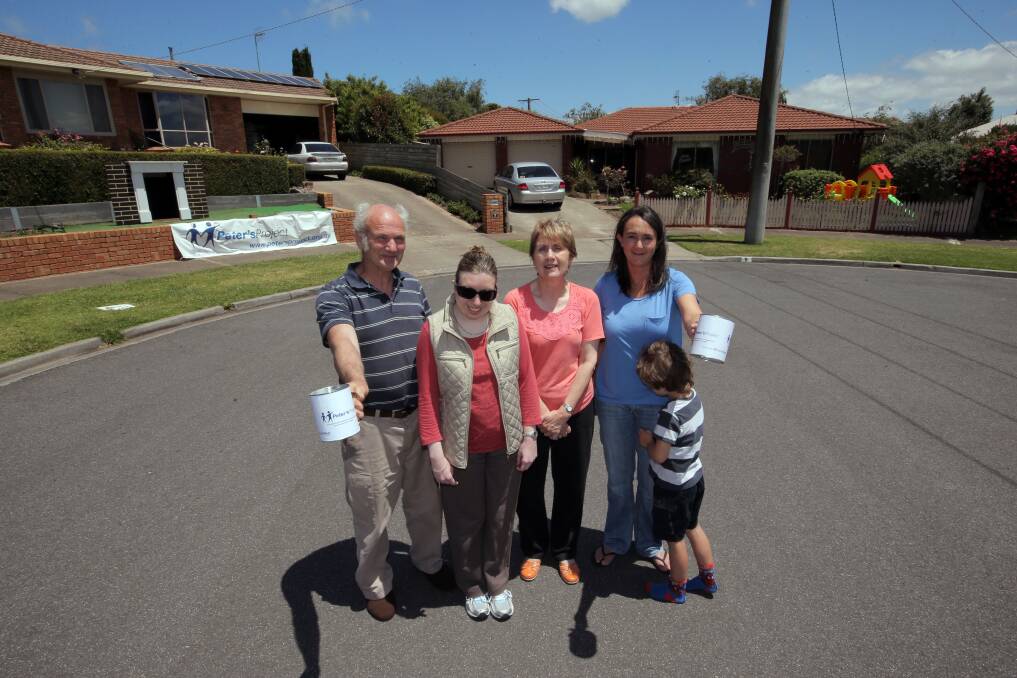 Eliza Court residents Ian Anderson (left), Ellen Anderson, Marjorie Anderson, Nicole Adams and five-year-old Lachlan Astbury helped raise $6000 for Peter’s Project by collecting from visiting cars admiring their street’s Christmas lights.  