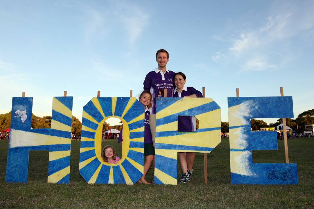 Mark Lee, who cut the ribbon at Friday night’s Relay For Life opening ceremony, helps spell out the event’s message with his girlfriend Sheridan White (right), Sheridan’s daughter Laila Kilby (left), 3, and Mark’s daughter Sada Lee, 6. 
