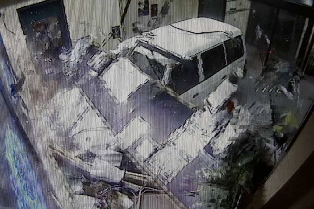 Moment of impact: A security camera image of the Pajero demolishing the police station's reception desk.