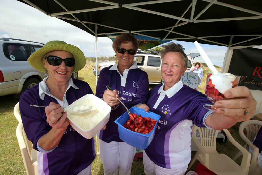 Timboon Rail Trailors and Lions Relay for Life team members Lorraine Norton (left), Lesley Togni and Maureen Clements raised money by selling strawberries and cream. 