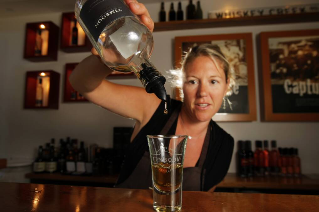 That’s your lot: Jodi Clarke gets the last drops from a bottle of Timboon Railway Shed Distillery’s precious whiskey.