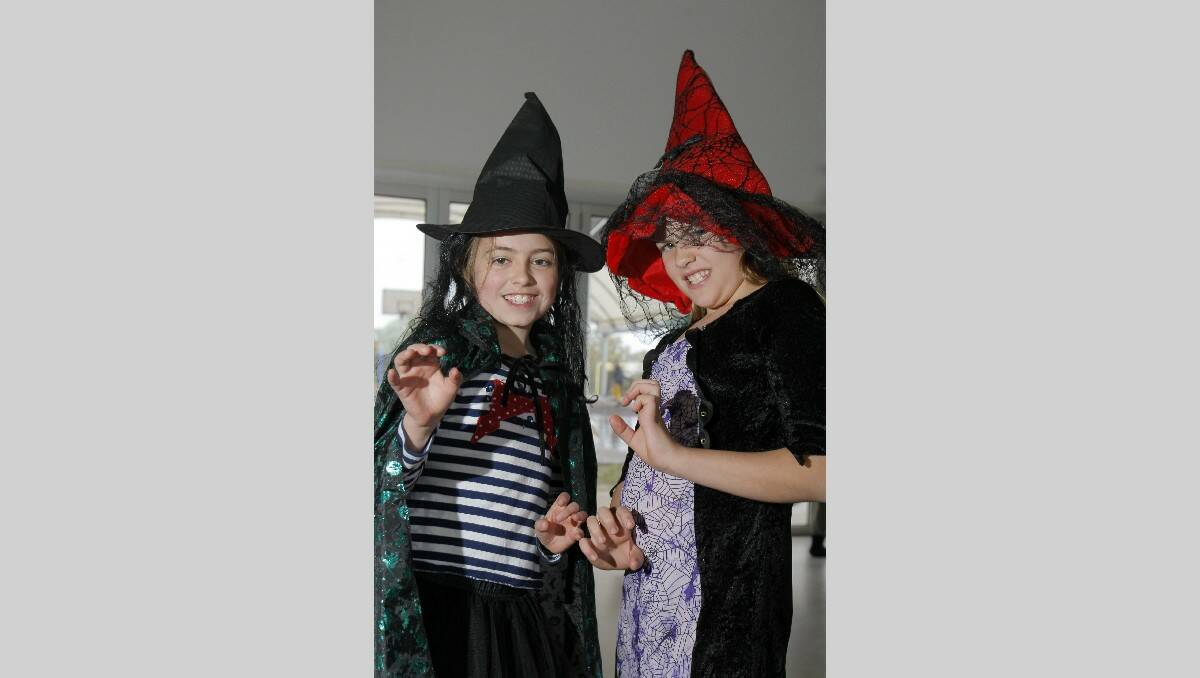 Dressed up as evil witches at the Merrivale Primary School science day, Rachael Wallace, 9, left, and Annabel Johnson, 10. Picture: ROB GUNSTONE
