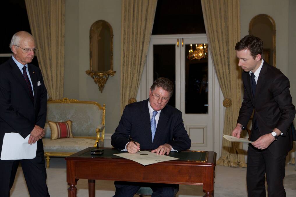 Dennis Napthine being sworn in at Government house on Wednesday night. Photo: Paul Jeffers