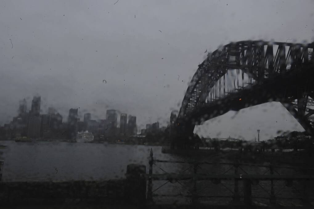 The Sydney Harbour Bridge is seen as the remnants of Cyclone Oswald pass Sydney on Tuesday. Photo by Mick Tsikas