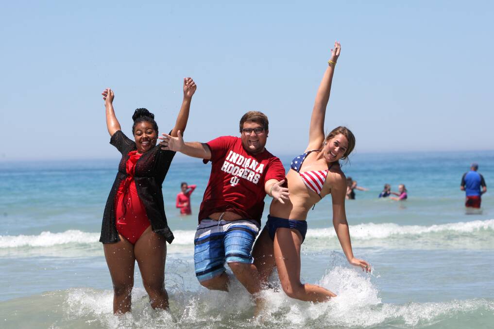 Paige Freeman (left), David Saling and Afton Conner, from Western Kentucky University, enjoy a taste of authentic Aussie beach weather at Warrnambool’s Lady Bay beach. 