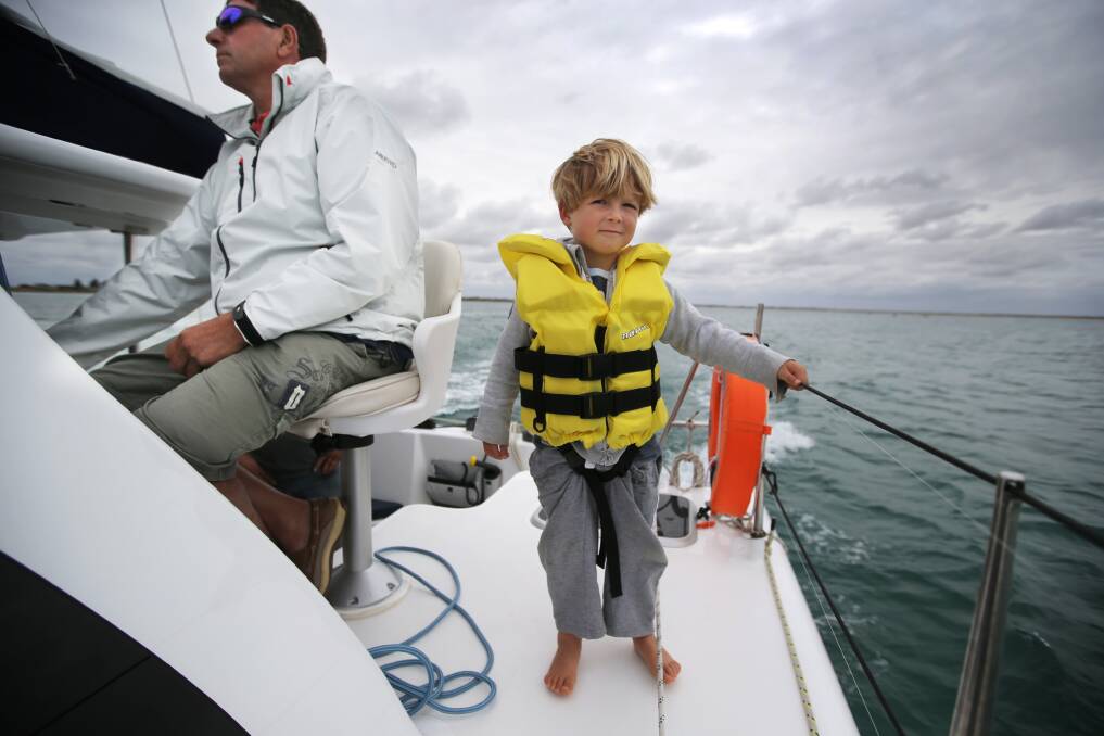 Max Dance, 3, of Port Fairy, gets his sea legs sailing in calm seas off East Beach yesterday