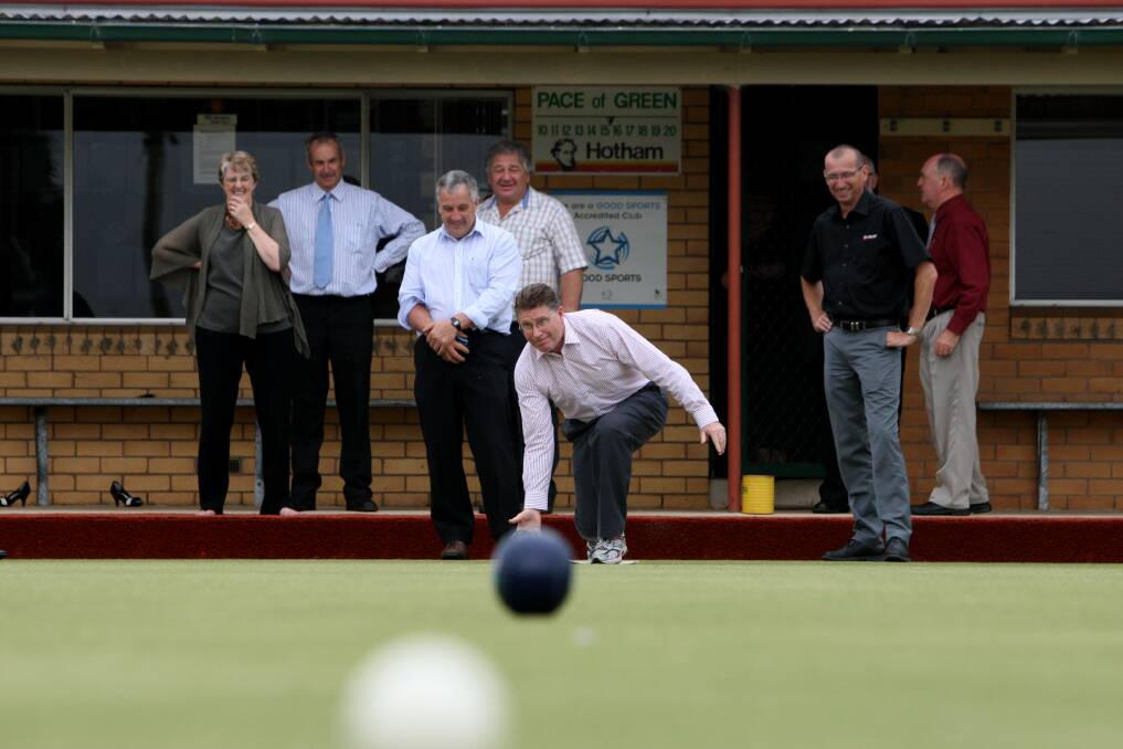 Denis Napthine sends one down the greens at the Koroit Bowls Club.