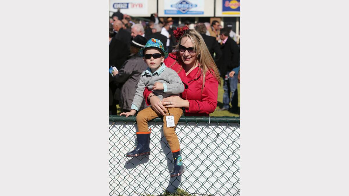 Olivia Greene and son Arlo, 3, cheer on the horses.