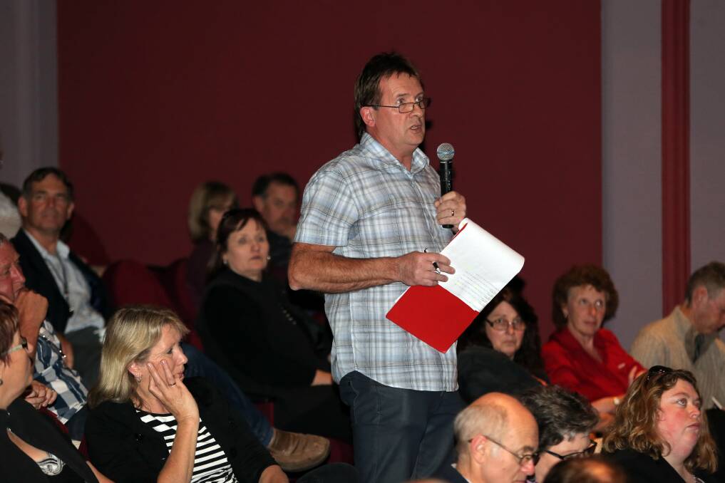 Warrnambool businessman Peter Roberts (left) airs his grievances at the Warrnambool Telstra exchange fire public meeting held at the Lighthouse Theatre last night.