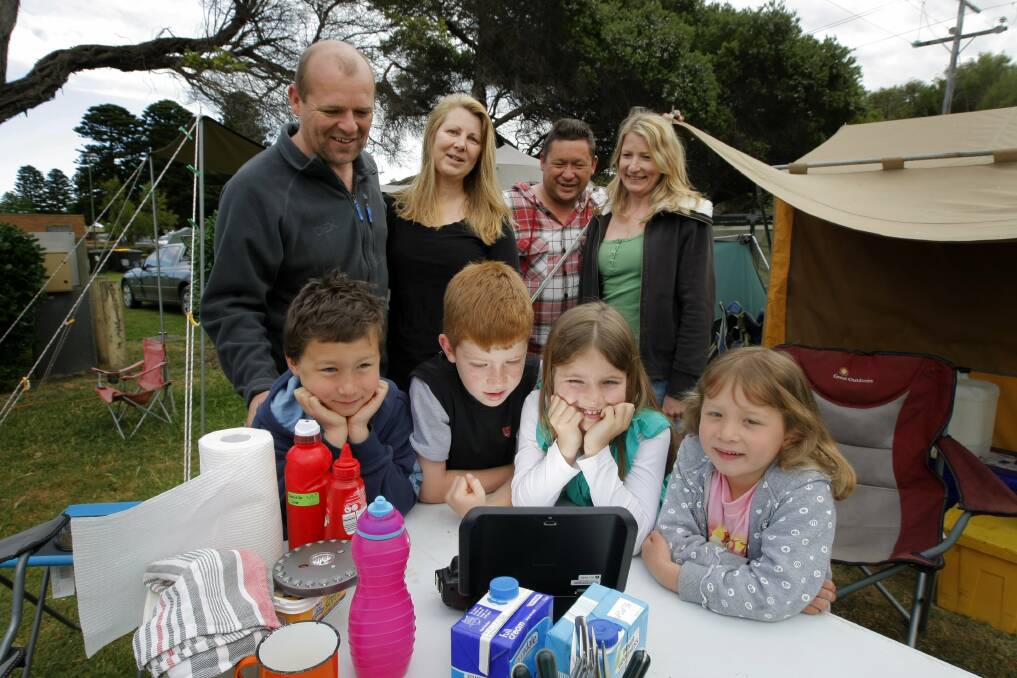 Surfside campers (front left to right) Kane Law, eight, Harrison King, eight, Sophie King, seven, Danielle Law, five, and (back left to right) Steven King, Jennie King, Jason Law and Andrea Law, all from Ivanhoe, gather around to watch the Melbourne Cup, on a long weekend.