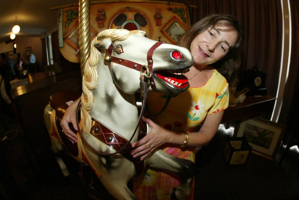 Gaye George from Obsessions Antiques of Bendigo at Warrnambool Antiques and Collectables Fair with an Australian Roebuck Carousel from Melbourne's Foyes department store.