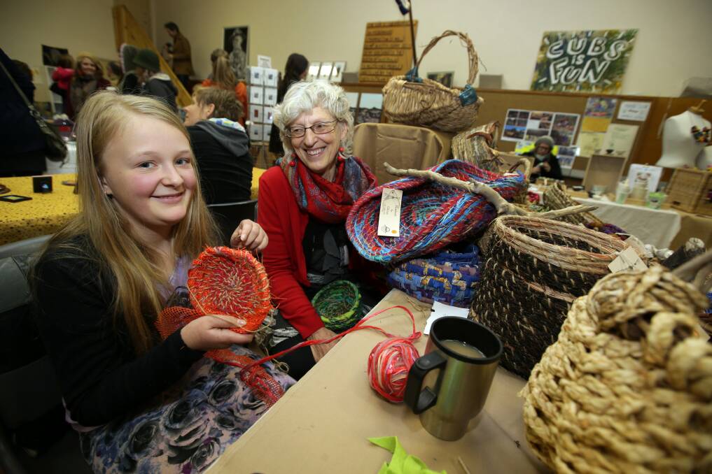 Imogene Tonks, 11, learns to make her own basket from Killarney's Cherree Densley. Picture DAMIAN WHITE