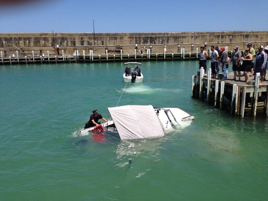 TWO men escaped unhurt after their fishing boat capsized in Warrnambool's Lady Bay.
